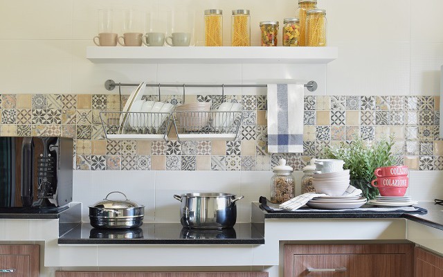 modern ceramic kitchenware and utensils on the black granite counter top