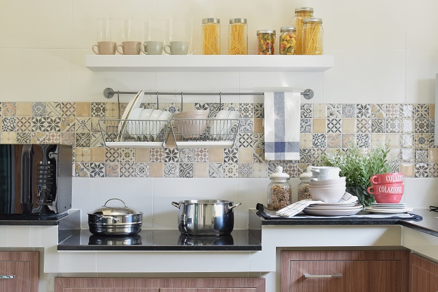 modern ceramic kitchenware and utensils on the black granite counter top